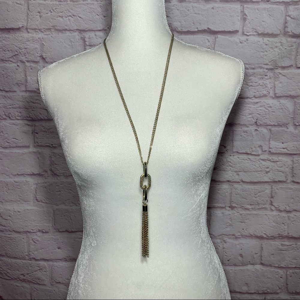 Long gold colored chain and pendent tassel necklace